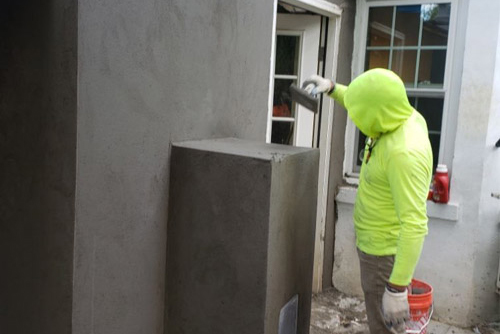 Man doing stucco.